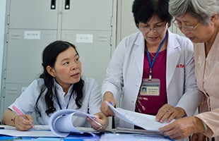 Healthcare workers reviewing files together